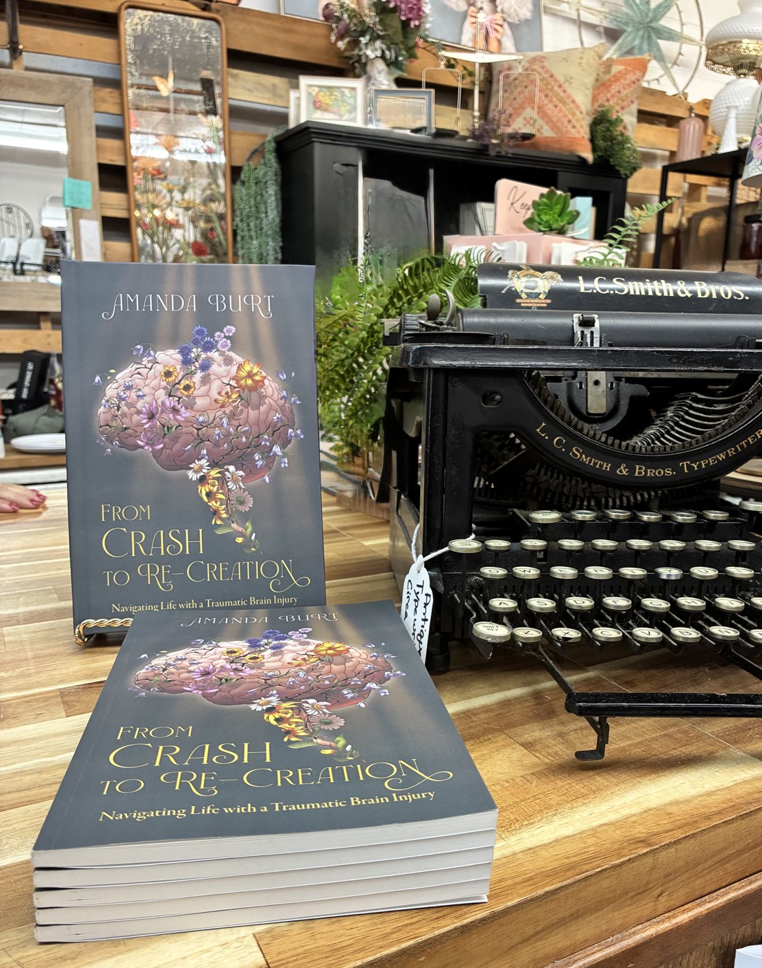 Copies of From Crash to Re-Creation beside a vintage typewriter